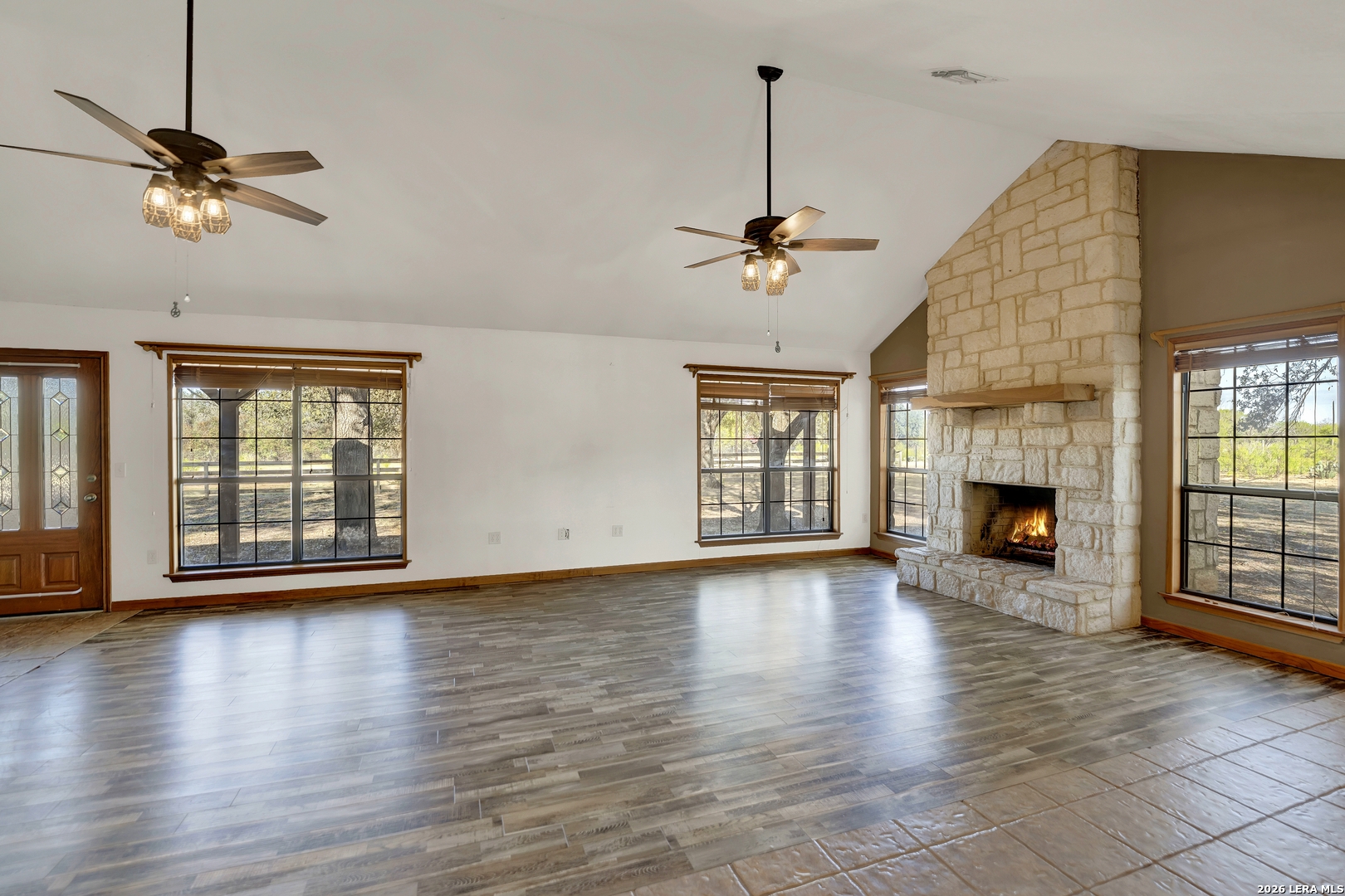386 County Road 763 Devine, TX 78016 - Photo 25 of 49 a view of empty room with wooden floor and fireplace
