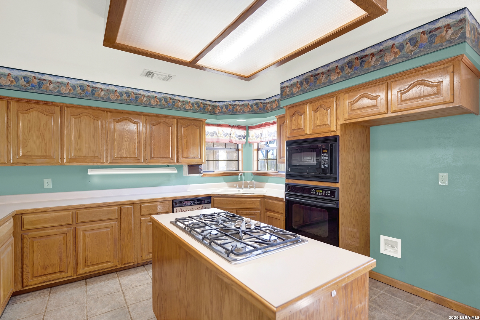 386 County Road 763 Devine, TX 78016 - Photo 28 of 49 a kitchen with a stove a sink and a refrigerator