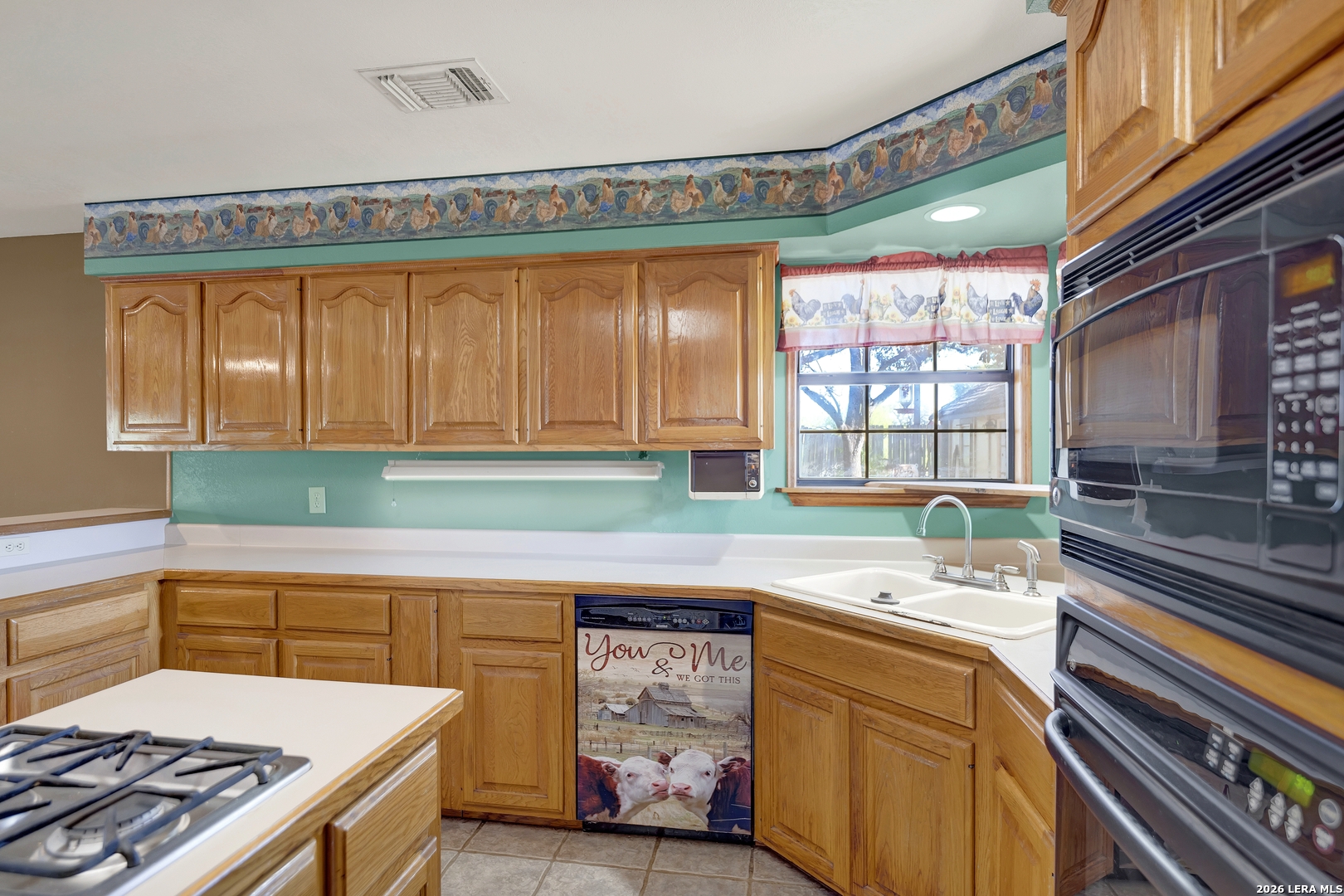 386 County Road 763 Devine, TX 78016 - Photo 31 of 49 a kitchen that has a cabinets and a stove