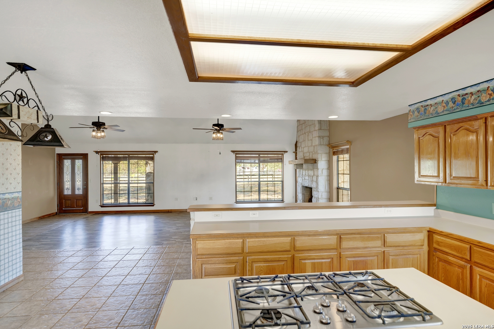 386 County Road 763 Devine, TX 78016 - Photo 32 of 49 a kitchen with stainless steel appliances kitchen island granite countertop a stove and a sink