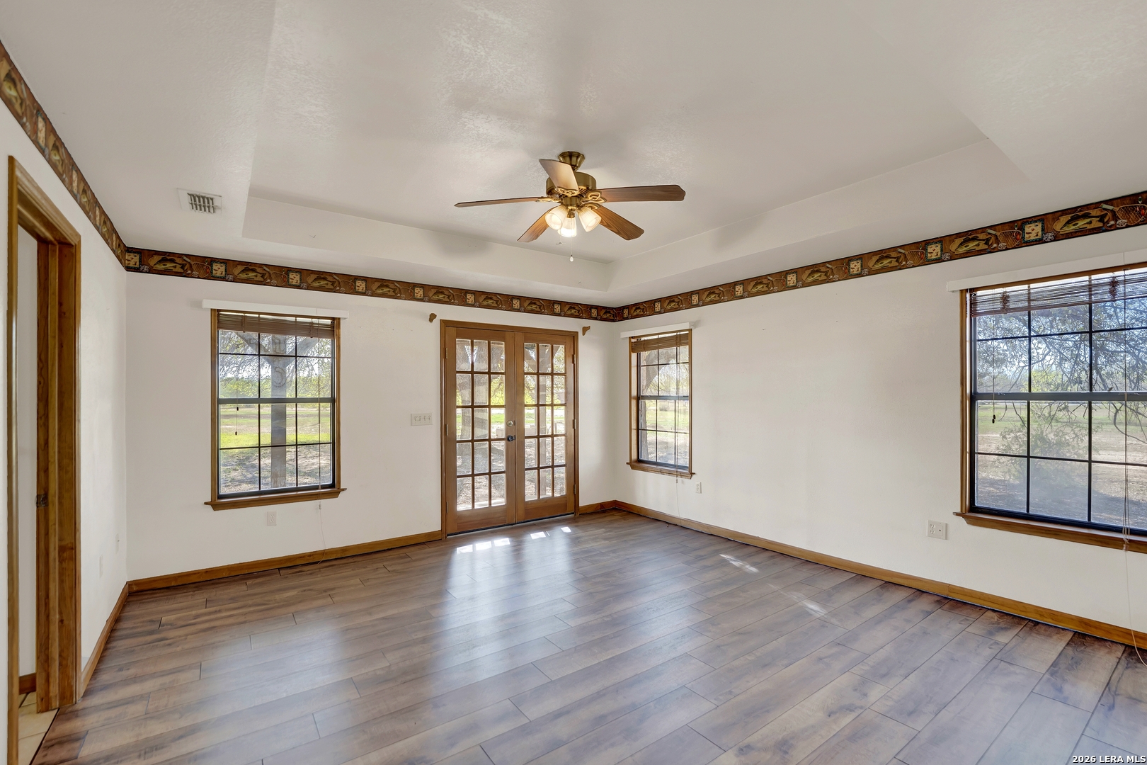 386 County Road 763 Devine, TX 78016 - Photo 44 of 49 a view of an empty room with window and wooden floor