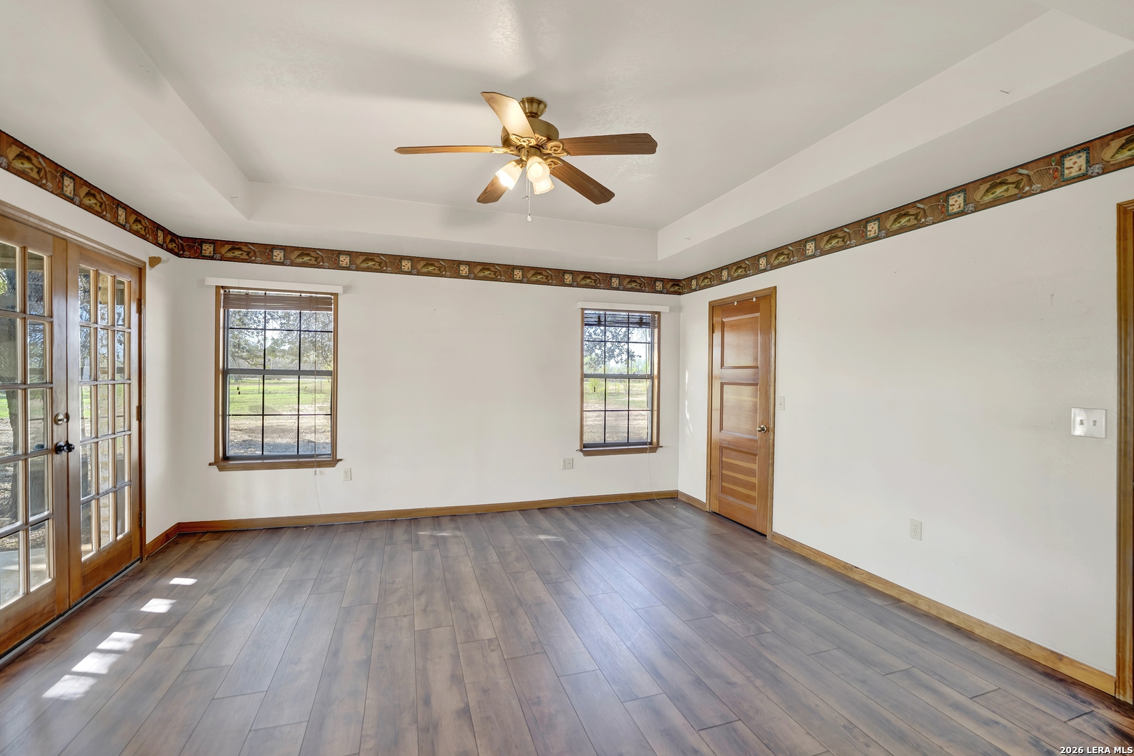 386 County Road 763 Devine, TX 78016 - Photo 45 of 49 wooden floor in an empty room with a window