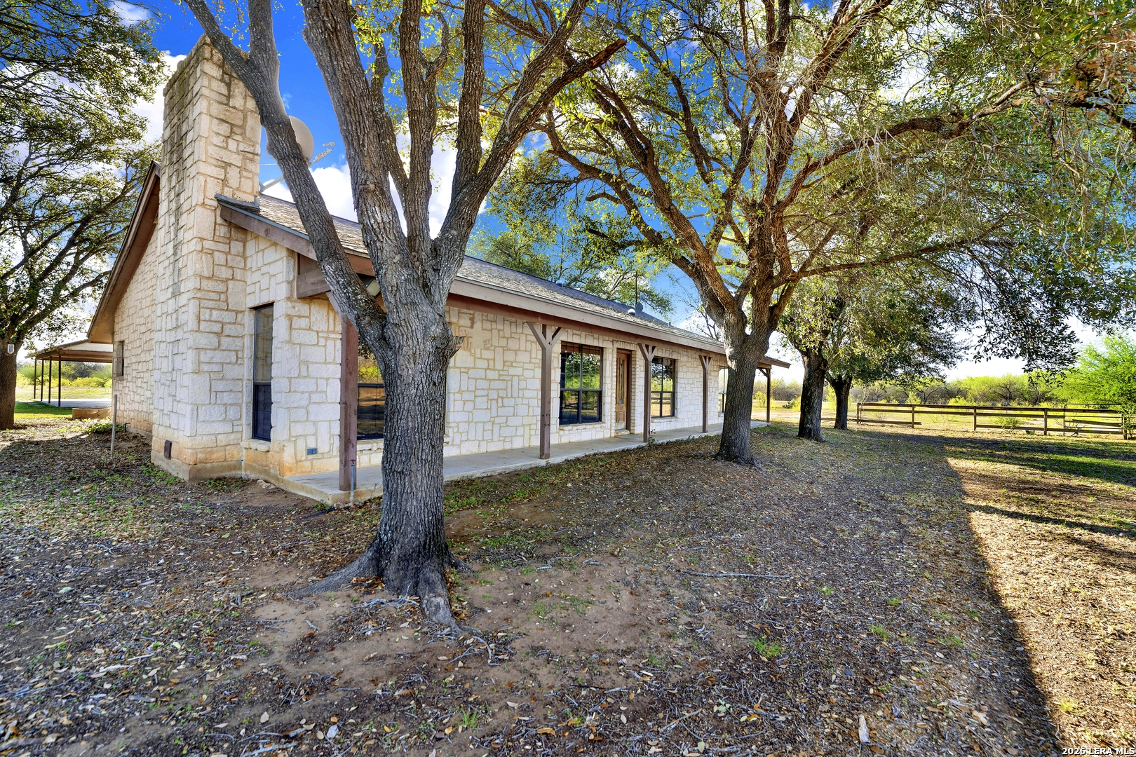 386 County Road 763 Devine, TX 78016 - Photo 10 of 49 a view of a house with a yard and large tree
