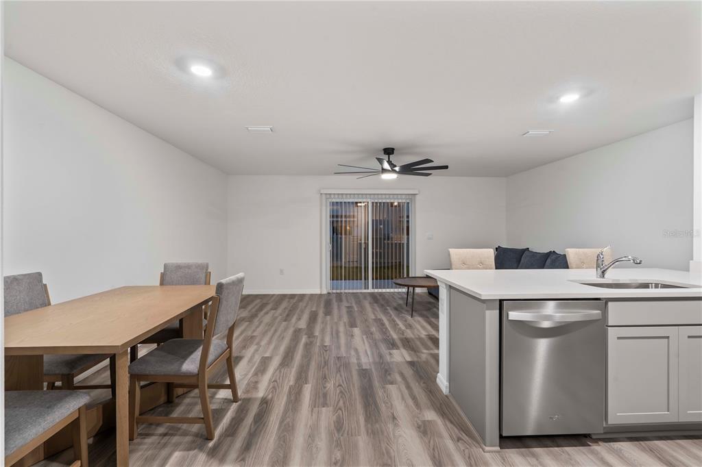 959 Spotted Egret Loop Ruskin, FL 33570 - Photo 11 of 36 a view of a dining room with furniture and wooden floor
