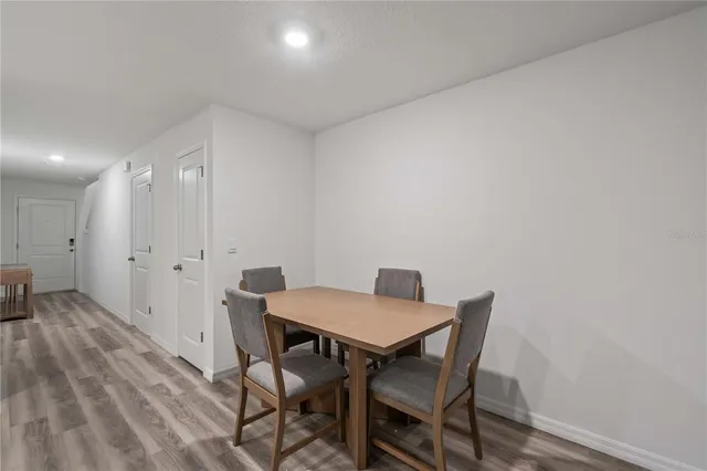 a view of a dining room with furniture and wooden floor