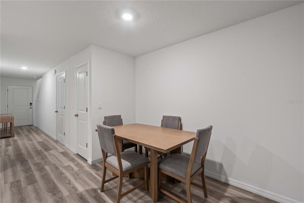 959 Spotted Egret Loop Ruskin, FL 33570 - Photo 13 of 36 a view of a dining room with furniture and wooden floor