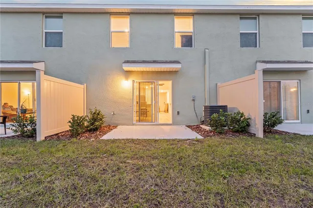 a view of a house with backyard and porch