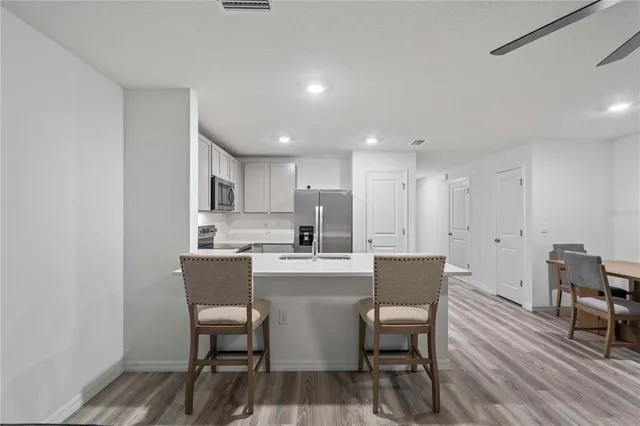 a dining room with furniture and wooden floor