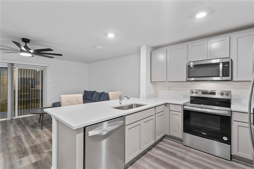 959 Spotted Egret Loop Ruskin, FL 33570 - Photo 22 of 36 a kitchen with a sink stove and microwave