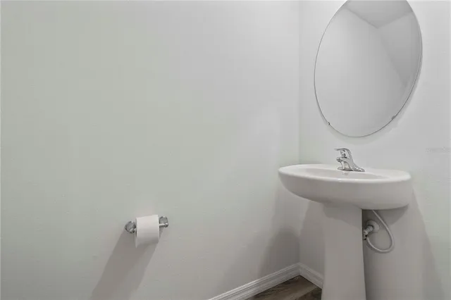 a bathroom with a sink and mirror