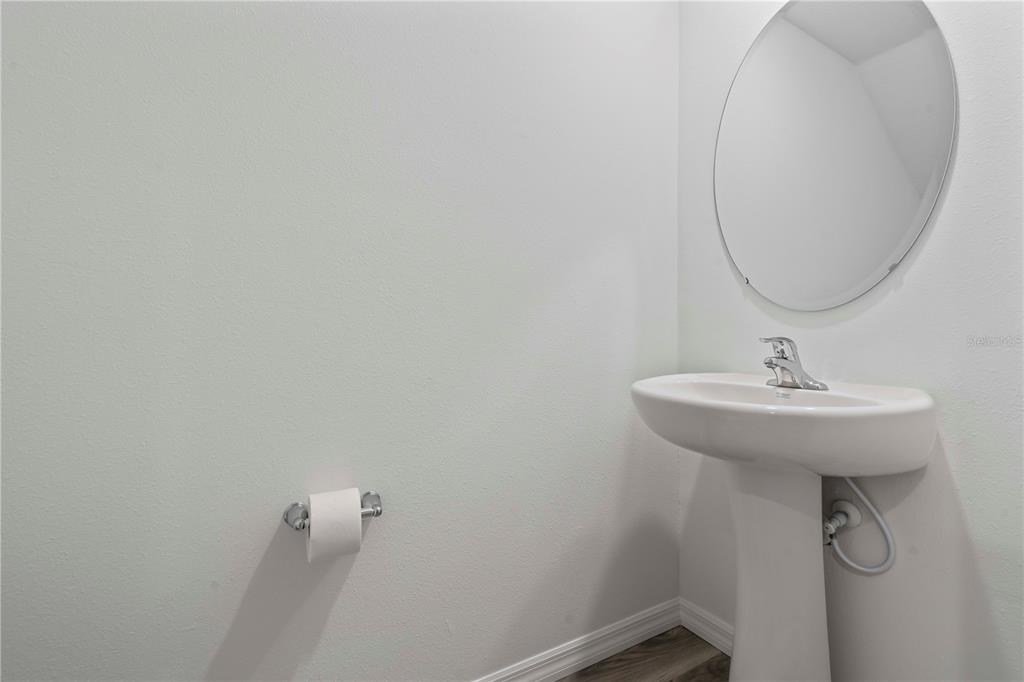 959 Spotted Egret Loop Ruskin, FL 33570 - Photo 25 of 36 a bathroom with a sink and mirror