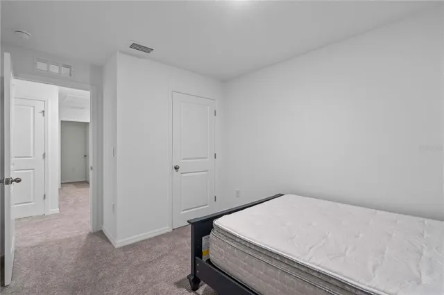 a room with a bed and utility room