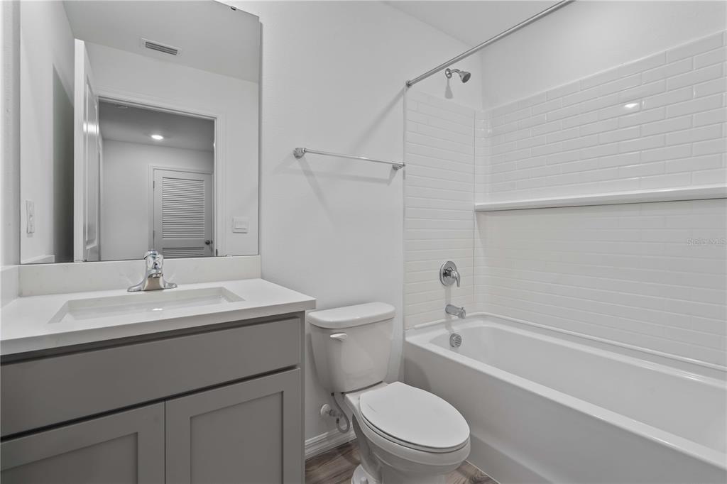 959 Spotted Egret Loop Ruskin, FL 33570 - Photo 35 of 36 a bathroom with a sink a toilet and shower