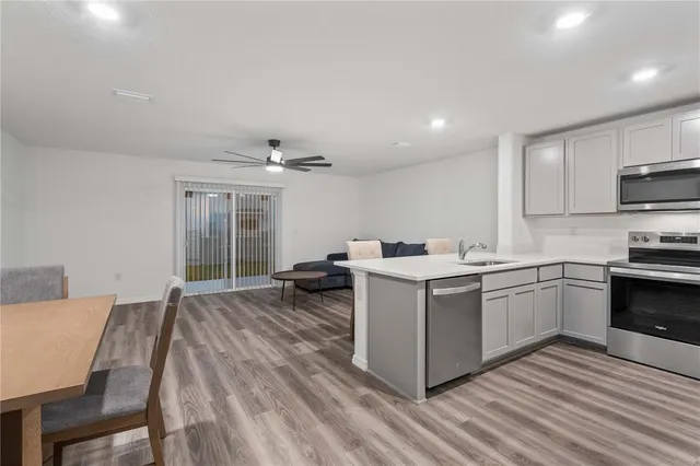 a kitchen with a sink and a stove top oven
