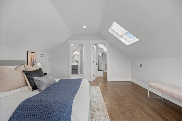 a spacious bedroom with a bed and a chandelier