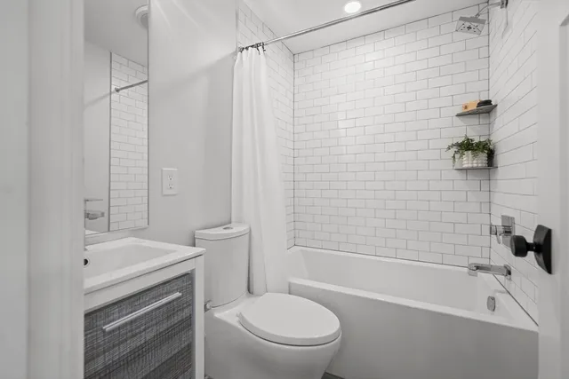 a bathroom with a sink a toilet and a bathtub