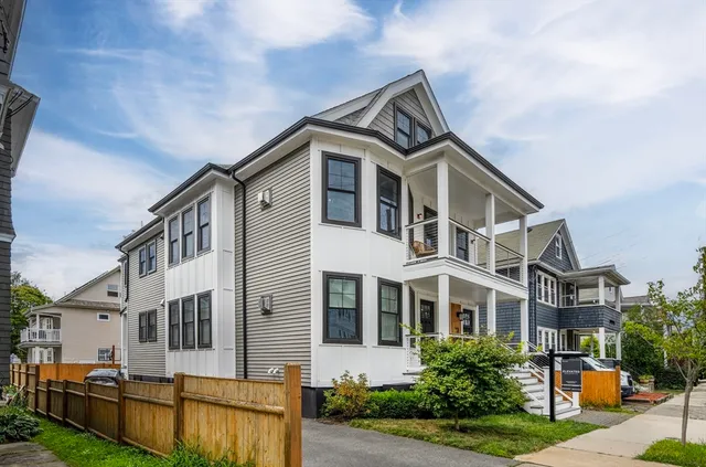 a front view of a house with yard and trees