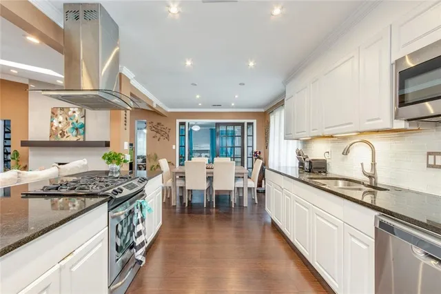 a living room with furniture a flat screen tv and a large window