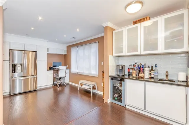 a living room with lots of furniture wooden floor and a table