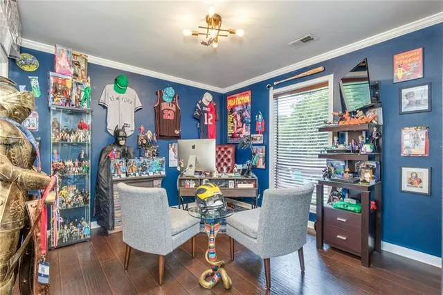 a living room with furniture a ceiling fan and a walk in closet