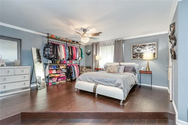 a bedroom with furniture and a wooden floor