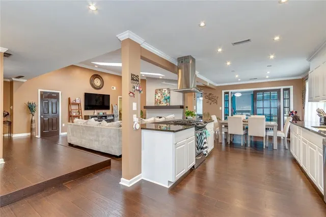 a kitchen with stainless steel appliances granite countertop a sink stove and microwave