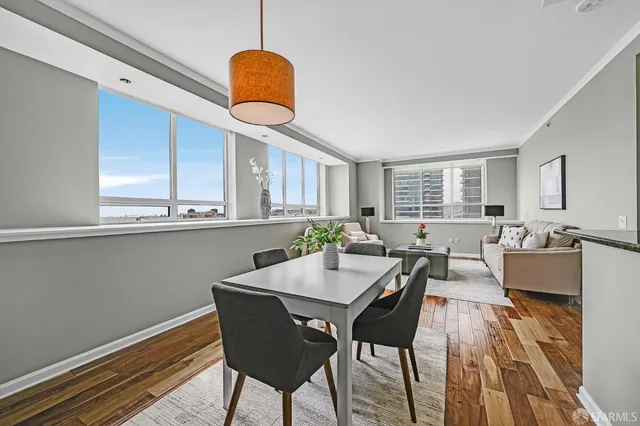 a view of a dining room with furniture window and wooden floor