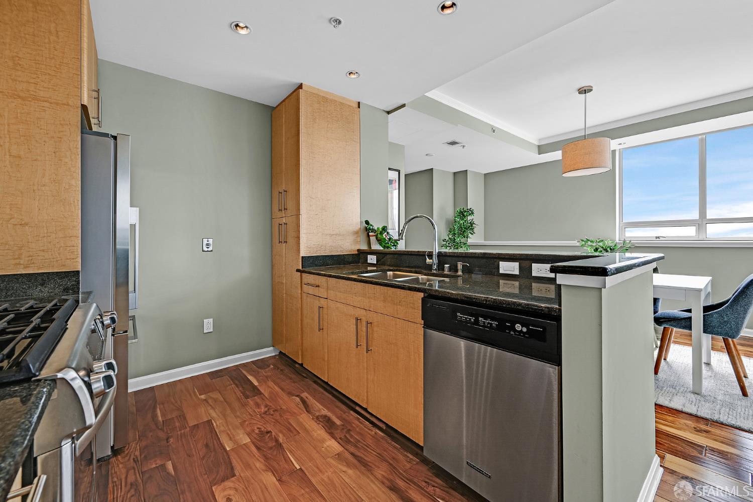400 Beale Street, Unit 2006 San Francisco, CA 94105 - Photo 13 of 40 a kitchen with a sink stove and cabinets