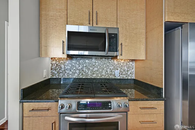 a stove top oven sitting inside of a kitchen