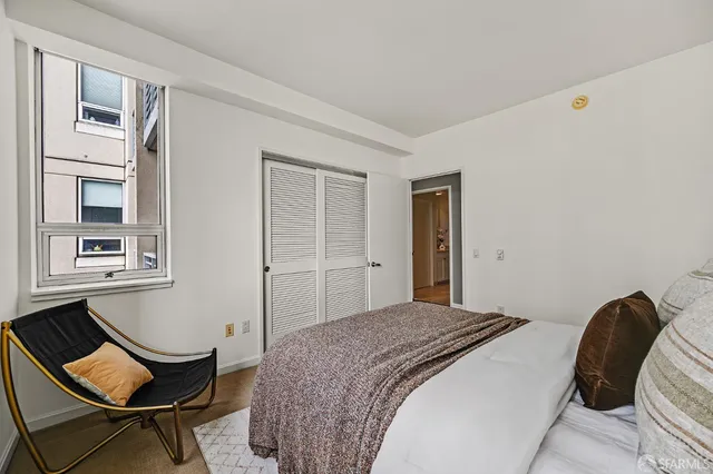 a bedroom with a bed and chair