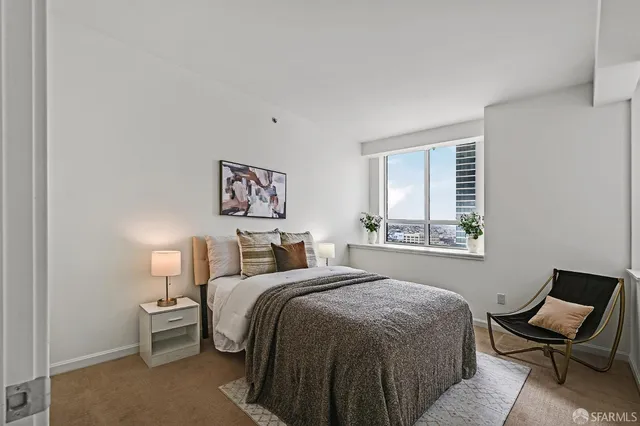 a bed room with a bed and chair