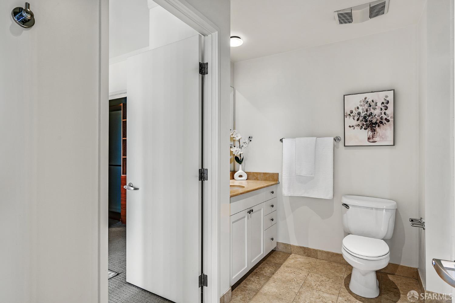 400 Beale Street, Unit 2006 San Francisco, CA 94105 - Photo 22 of 40 a bathroom with a toilet sink vanity and mirror