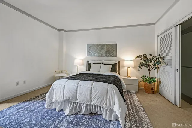 a bedroom with a bed and a potted plant