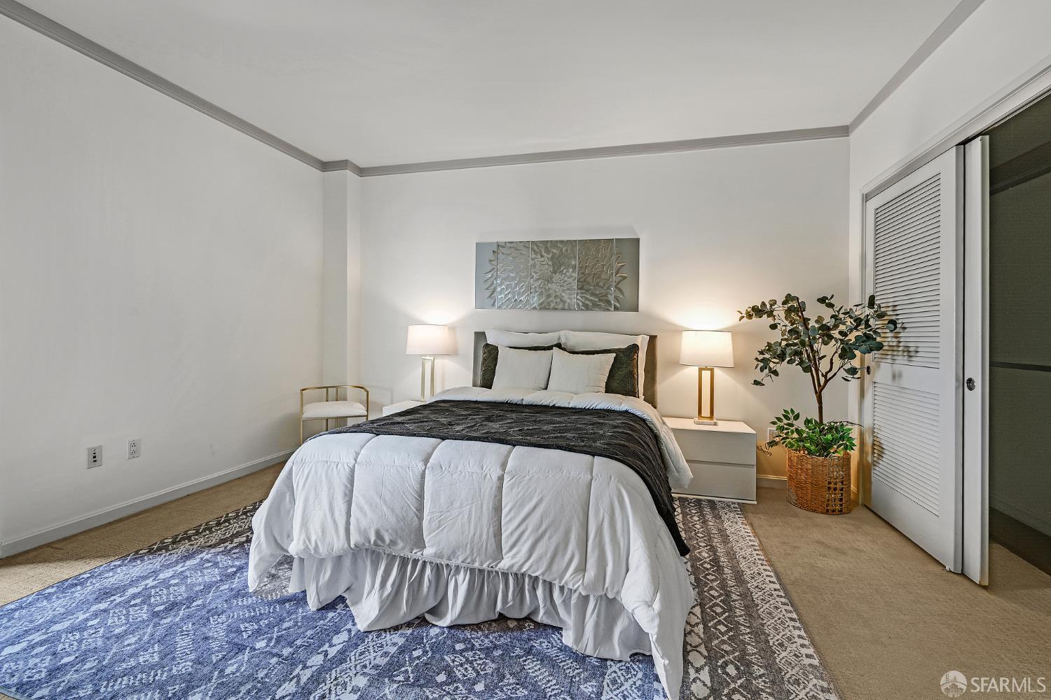 400 Beale Street, Unit 2006 San Francisco, CA 94105 - Photo 25 of 40 a bedroom with a bed and a potted plant