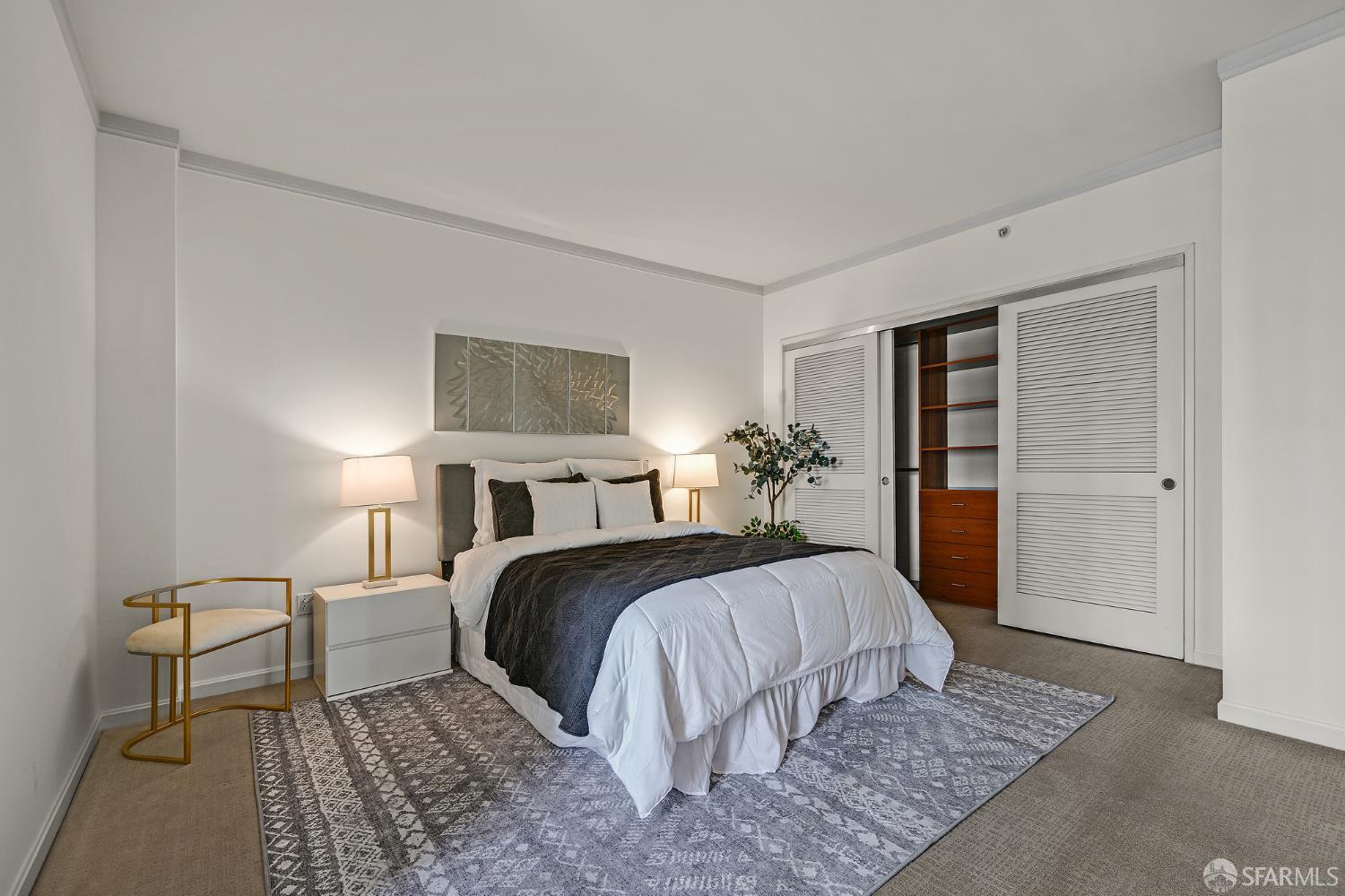 400 Beale Street, Unit 2006 San Francisco, CA 94105 - Photo 26 of 40 a bedroom with a large bed a potted plant and a rug