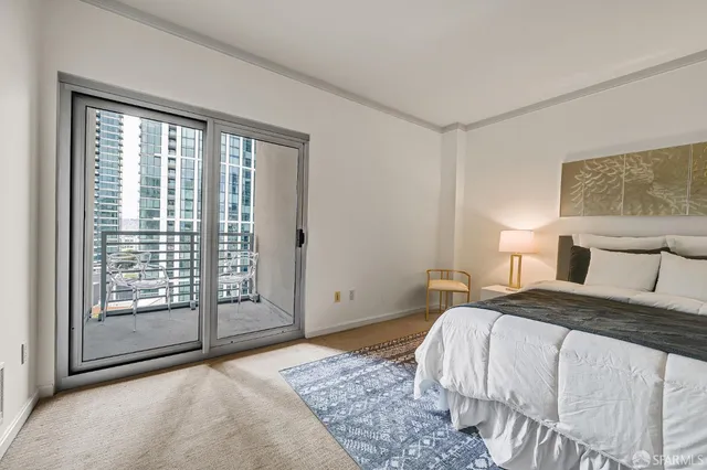 a bedroom with a large bed and a large window