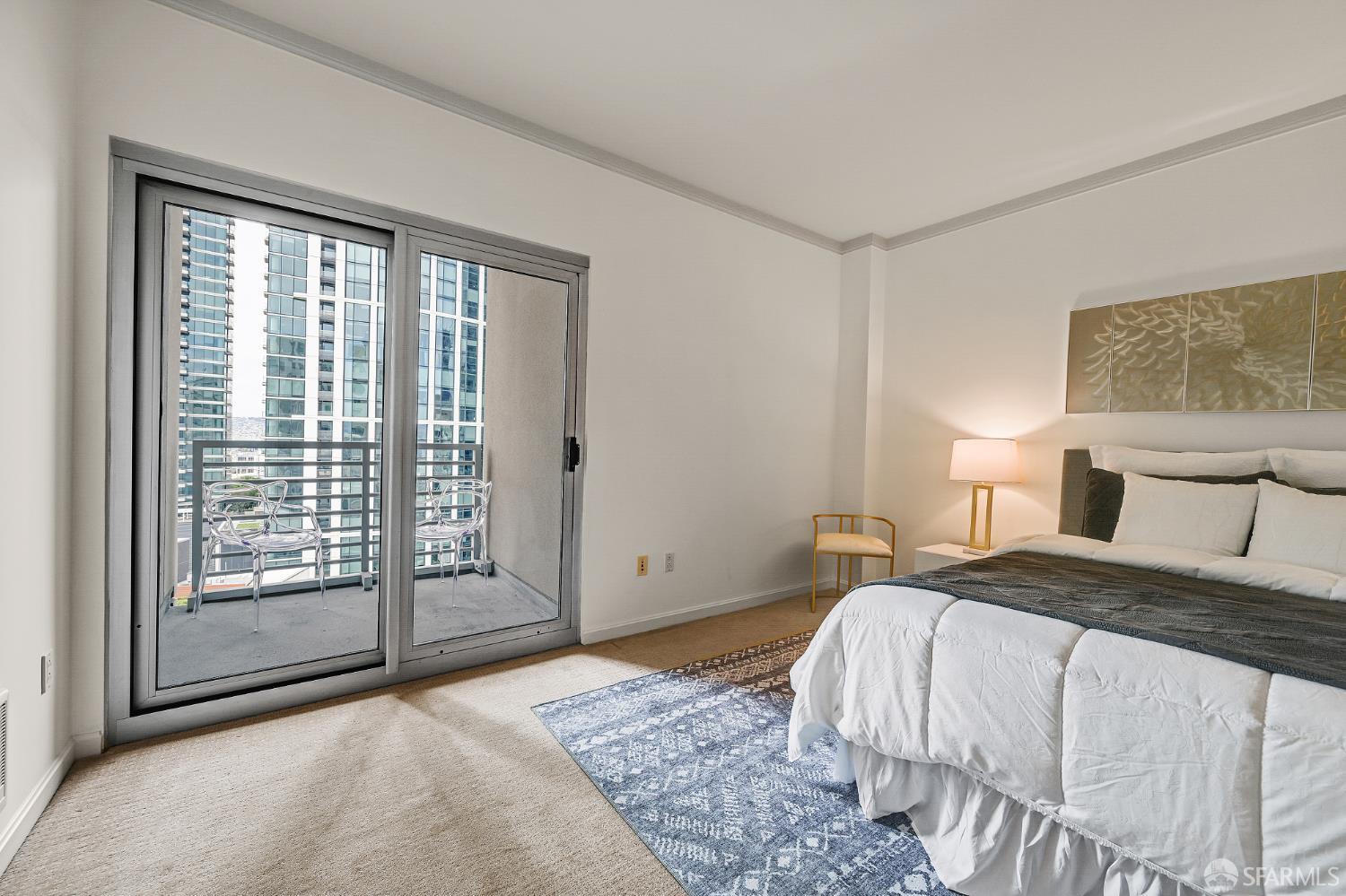 400 Beale Street, Unit 2006 San Francisco, CA 94105 - Photo 30 of 40 a bedroom with a large bed and a large window