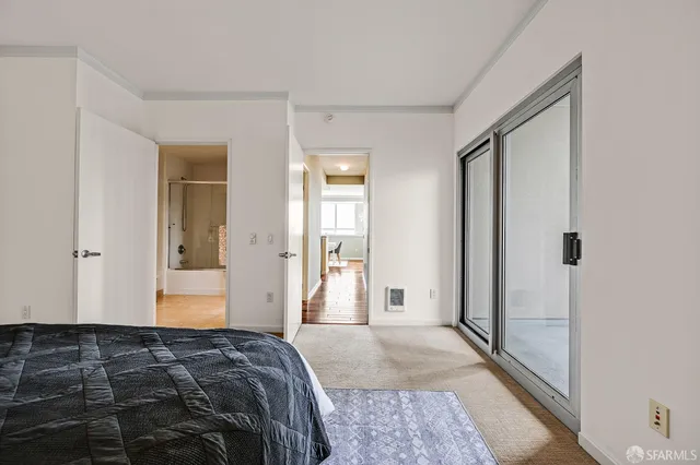 a bedroom with a bed and a mirror