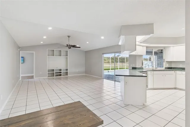 a bathroom with a granite countertop sink a bathtub and a shower