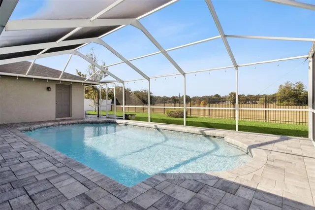 an empty room with fan and entrance