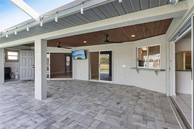 a view of an empty room with closet and a window
