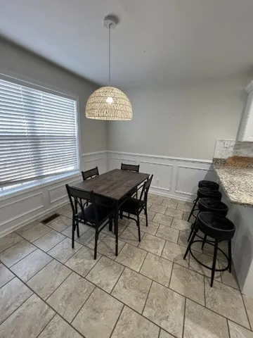 a view of a dining room with furniture and window
