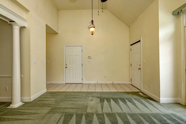 a view of a room with wooden floor