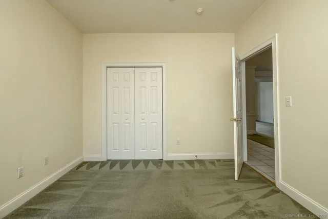 an empty room with closet area