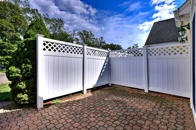 a view of a house with a wooden fence