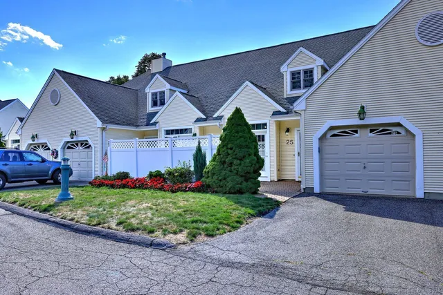 a front view of a house with a garden