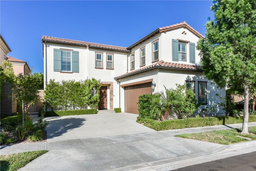 67 Elmdale Irvine, CA 92620 - Photo 1 of 39 a front view of a house with a yard and potted plants