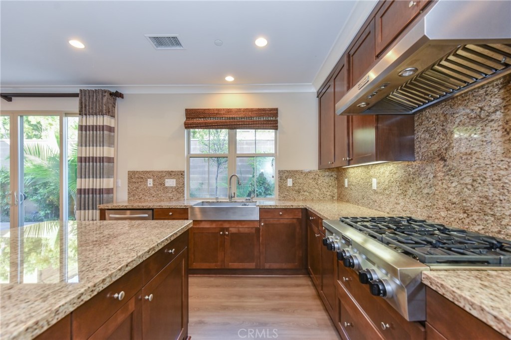 67 Elmdale Irvine, CA 92620 - Photo 11 of 39 a large kitchen with granite countertop a stove and a sink