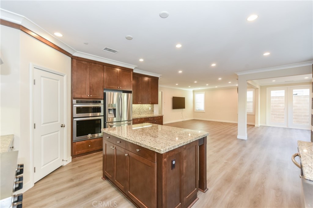 67 Elmdale Irvine, CA 92620 - Photo 12 of 39 a kitchen with a stove a refrigerator and a sink