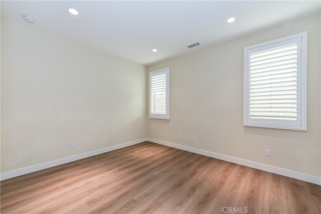 67 Elmdale Irvine, CA 92620 - Photo 18 of 39 an empty room with wooden floor and windows